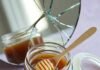 Expert Tips for Maintaining Healthy Skin Care with Natural Products Messy honey jar with dripping dipper, aloe, and turmeric print.