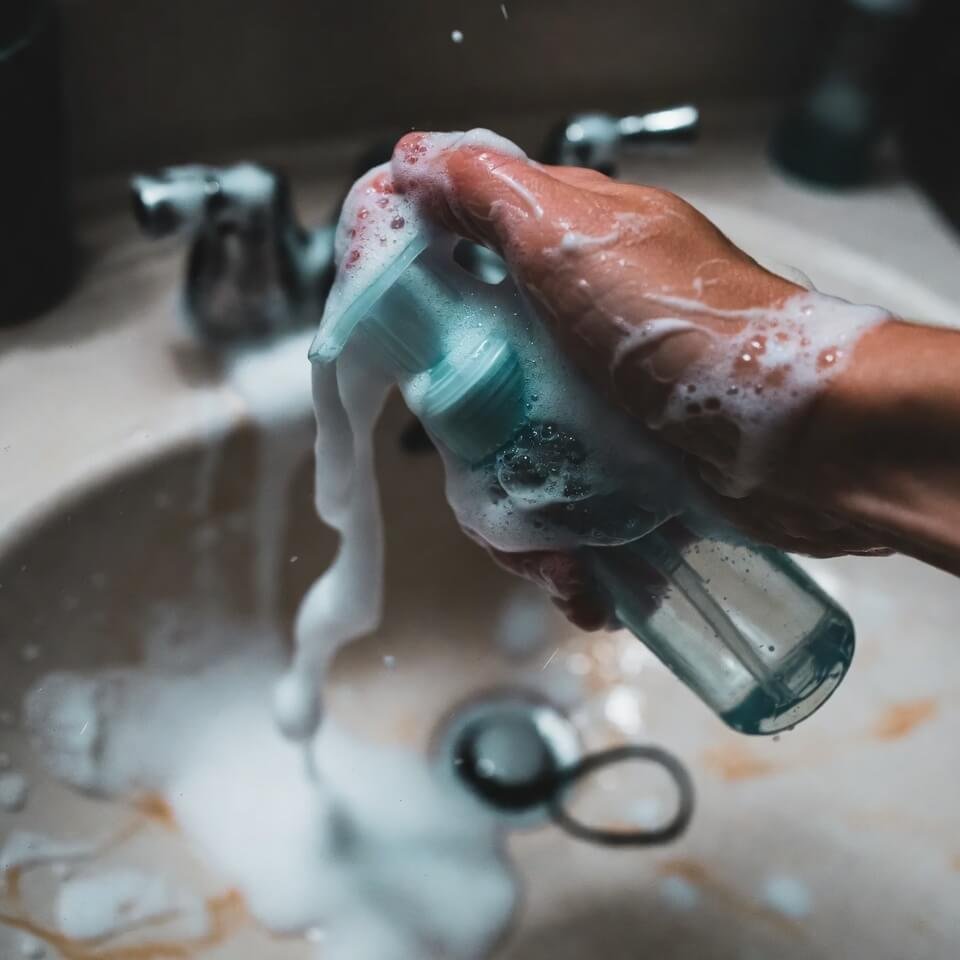 Messy flat-lay of half-used skincare products on crumpled towel