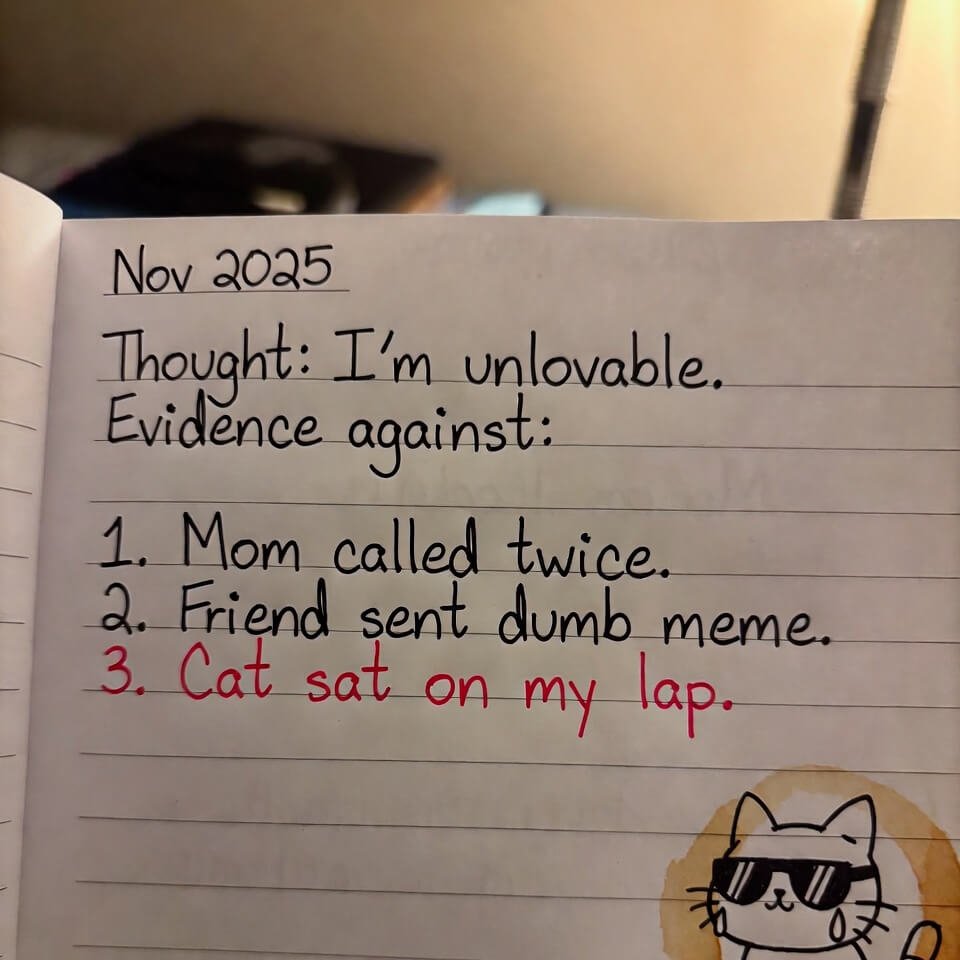 Messy notebook page challenging "I'm unlovable" thought with evidence and crying cat doodle.