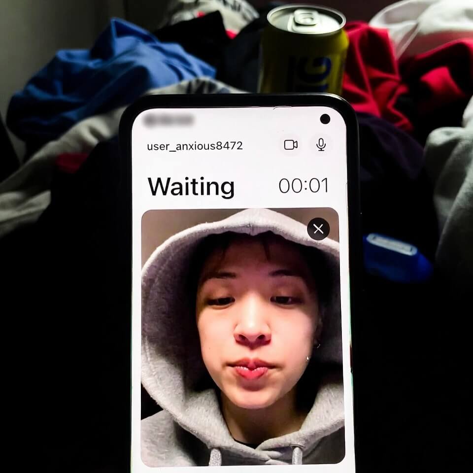 Awkward teletherapy waiting room screenshot with lag timer and hoodie selfie.