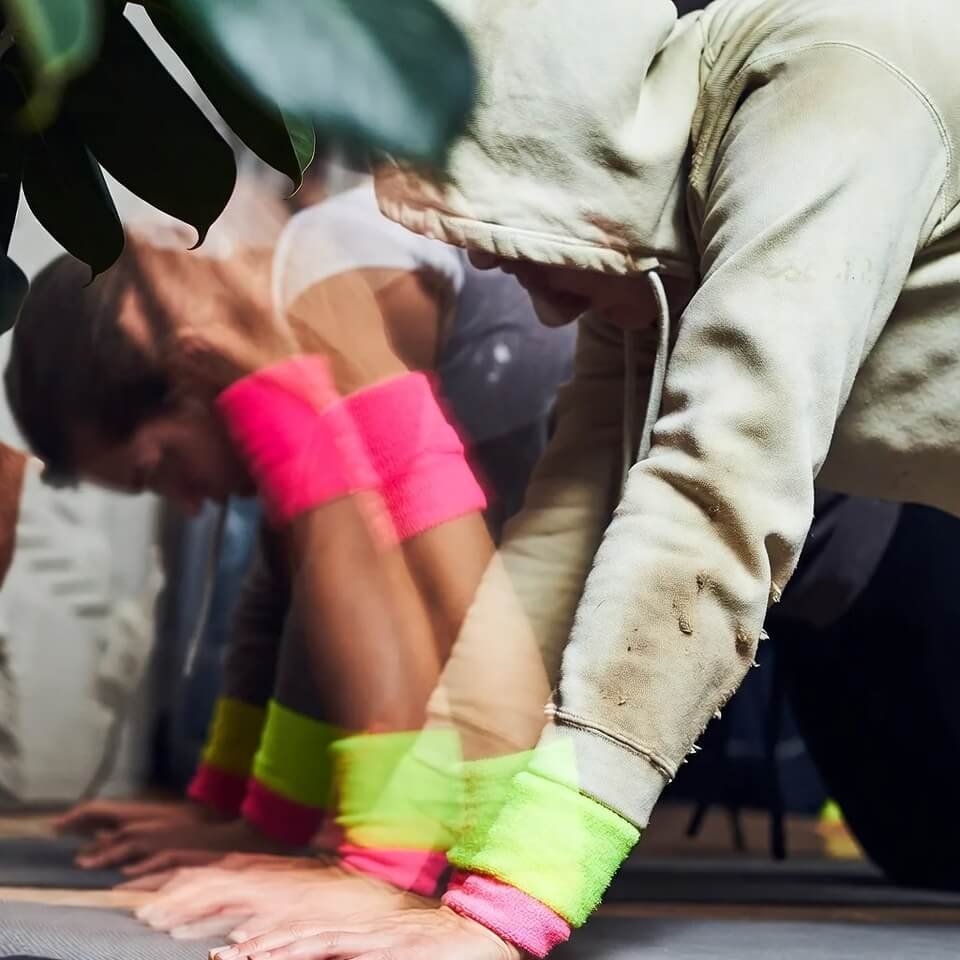 Close-up of clashing bright wristbands on exercise hoodie